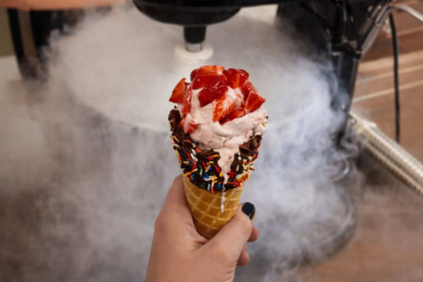 Fresh liquid nitrogen ice cream cone with strawberries and sprinkles at NitroInfusions